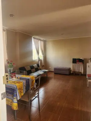 a living room with a table and a couch at Apartamento duplex en ICA in Pueblo Nuevo