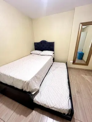 two twin beds in a room with a mirror at Downtown apartment in a residential area in Lima in Lima