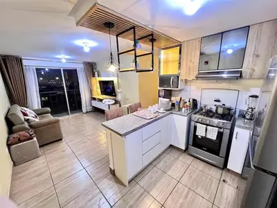 a kitchen and living room with a stove top oven at Downtown apartment in a residential area in Lima in Lima