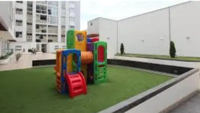 a toy train on the grass in a building at Acogedor departamento con cochera in Lima