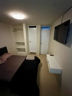 a small room with a bed and a tv at Habitación Matrimonial en el centro de la ciudad in Ayacucho