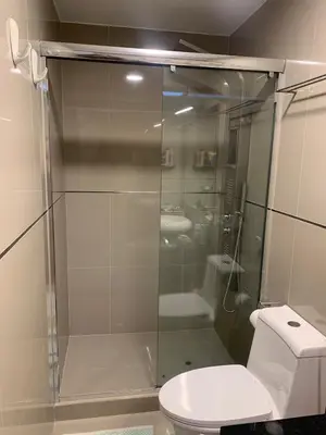 a bathroom with a glass shower with a toilet at Spacious apartment in Miraflores in Lima