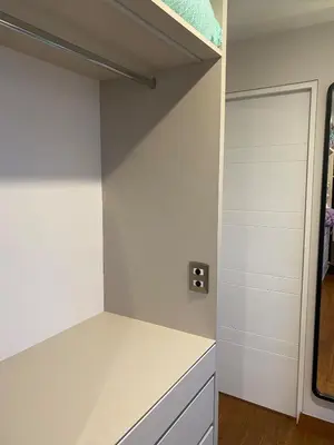 a closet with white cabinets and a door at Spacious apartment in Miraflores in Lima
