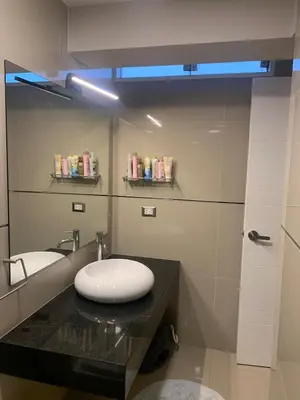 a bathroom with a sink and a mirror at Spacious apartment in Miraflores in Lima