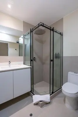a bathroom with a shower and a toilet and a sink at Brickell 2BR by Geko in Lima