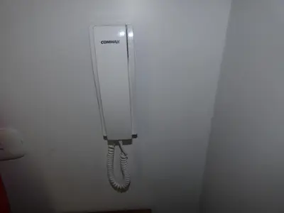 a white phone hanging on a wall at Hotel El Delfin in Lima