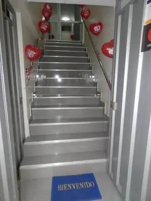 a stairway with red hearts and a blue welcome sign at Hotel El Delfin in Lima