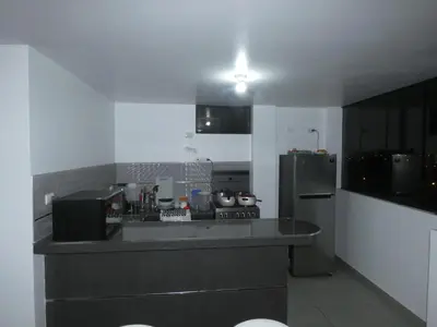 a kitchen with a stove and a refrigerator at Hotel El Delfin in Lima
