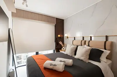 a bedroom with a large bed with two pillows on it at Torre Black in Lima