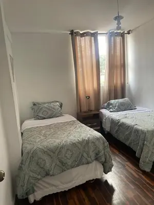 a bedroom with two beds and a window at Miraflores Dpto 3 dormitorios in Lima