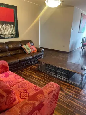 a living room with a couch and a coffee table at Miraflores Dpto 3 dormitorios in Lima