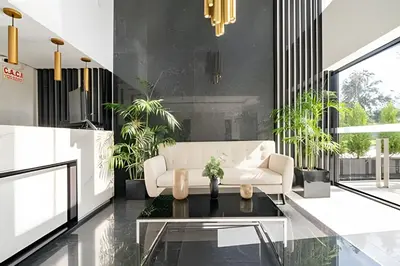 a living room with a white couch and a table at Edificio The Classic in Lima