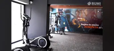 a gym with several cardio machines in a room at MiniHome Pietra di Prado in Lima