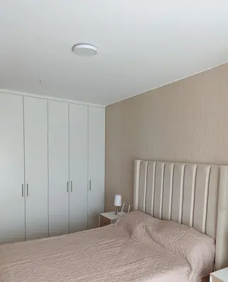 a bedroom with a bed and white cabinets at MiniHome Pietra di Prado in Lima