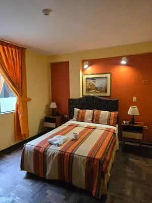 a hotel room with a bed and a window at Sahara Hotel in Lima