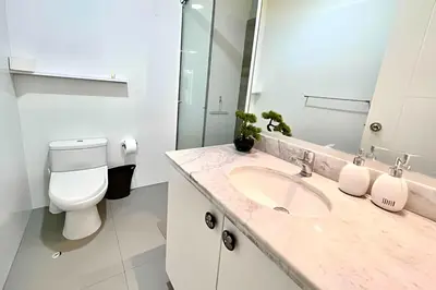 a white bathroom with a sink and a toilet at Modern Apartment between Miraflores & Surquillo in Lima
