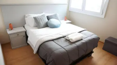 a bedroom with a large bed with white sheets and pillows at Cozy 2BR, Prime Barranco, 7th Flr in Lima