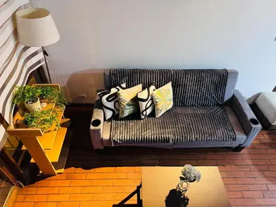a living room with a couch with pillows on it at Monterrico Polo Apart 4 - Frente Embajada USA in Lima