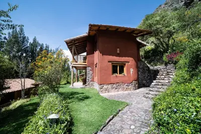 a small house on a hill with a pathway leading to it at Dreamy cabins in Urubamba