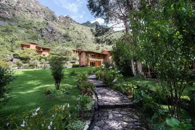 a house with a stone path in front of a yard at Dreamy cabins in Urubamba