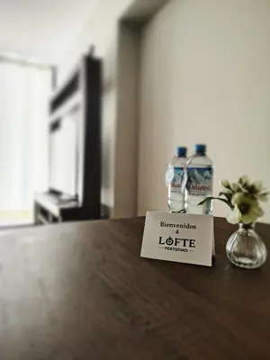 a hotel room table with a bottle of liquids on it at LOFTE Portofino, Departamento cerca de San Isidro in Lima