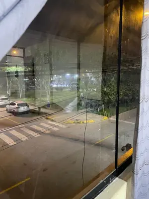 a window with a view of a street with a car at Habitacion amplia cerca al aeropuerto in Lima