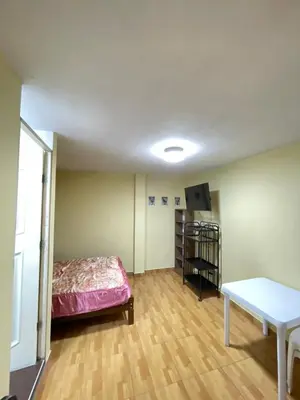 a room with a bed and a table in it at Habitacion privada cerca al aeropuerto in Lima