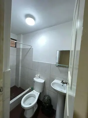 a bathroom with a toilet and a sink at Habitacion privada cerca al aeropuerto in Lima