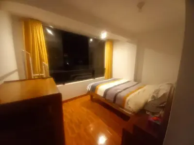 a small bedroom with a bed and a window at Habitación en Cusco in Cusco