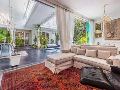a living room with a couch and a large window at Apartment in the historic central of the city in Cusco