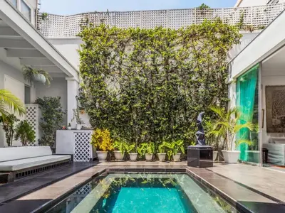 a pool in the backyard of a house with a large tree at Apartment in the historic central of the city in Cusco