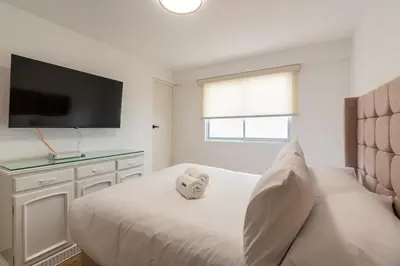 a bedroom with a bed with a teddy bear on it at Montclair 2BR by Geko in Lima
