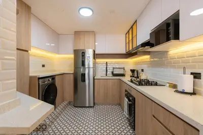 a kitchen with a refrigerator and a washer at Montclair 2BR by Geko in Lima