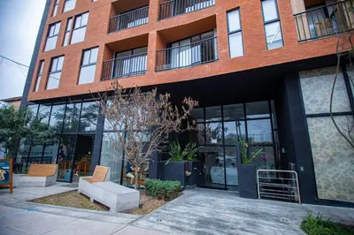 a red brick building with a bench in front of it at BSR Modern Spacious New Flat in Miraflores w/ Pool in Lima