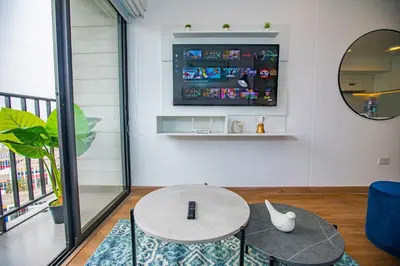 a living room with a table and a tv at BSR Modern Spacious New Flat in Miraflores w/ Pool in Lima