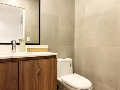 a bathroom with a toilet and a sink and a mirror at New 2D gym-grill Miraflores 1 block Malecón in Lima