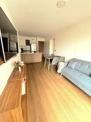 a living room with a blue couch and a table at Charming San Isidro Stay in Lima