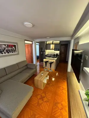 a living room with a couch and a table at Moderno Depa Céntrico en Abancay in Abancay