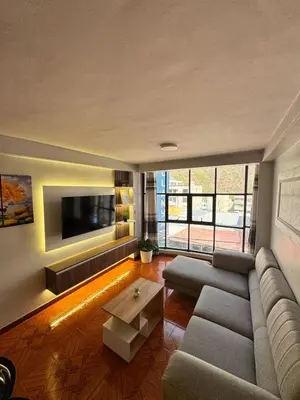 a living room with a couch and a tv at Moderno Depa Céntrico en Abancay in Abancay