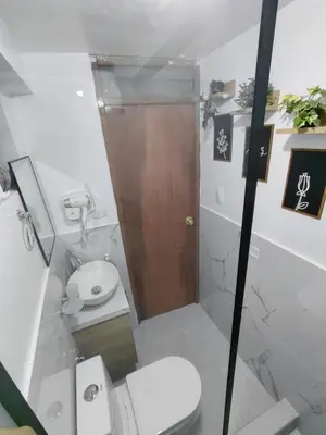 a small bathroom with a toilet and a shower at Moderno Depa Céntrico en Abancay in Abancay