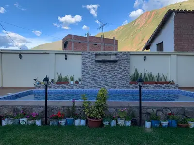 a house with a swimming pool in a yard at Casa de Campo en el Valle Sagrado de los Incas - Casa Brisas del Rio Sagrado in Huayllabamba