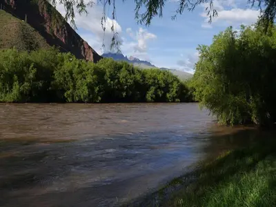 a view of a river with trees and a bridge at Casa de Campo en el Valle Sagrado de los Incas - Casa Brisas del Rio Sagrado in Huayllabamba