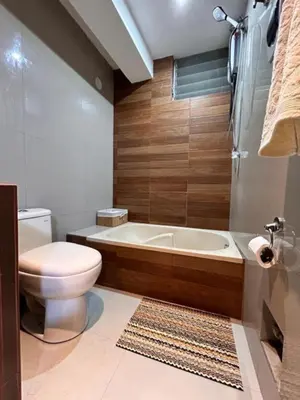 a bathroom with a toilet and a bath tub at Apartamento Lucky House Cusco in Cusco