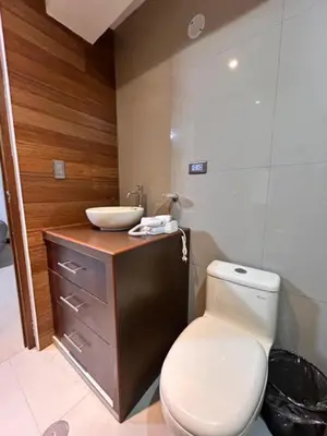 a bathroom with a white toilet and a sink at Apartamento Lucky House Cusco in Cusco