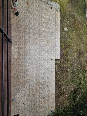 a brick wall next to the side of a building at Casa familiar en Oxapampa hasta 5 personas con cochera in Oxapampa