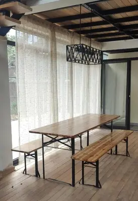 a table and benches in a room with a window at Casa familiar en Oxapampa hasta 5 personas con cochera in Oxapampa