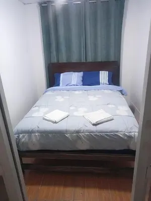 a bedroom with a bed with two towels on it at Departamento 1dormitorio 3A in Lima