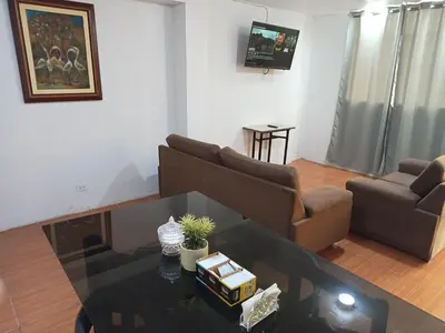 a living room with a couch and a table at Departamento 1dormitorio 3A in Lima