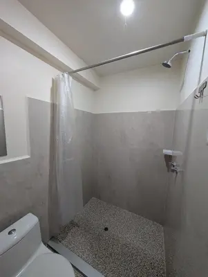 a bathroom with a shower and a toilet in it at TUMI Specialty Travel in Colcapampa