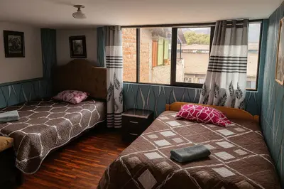 a bedroom with two beds and a window at Casa Victoria